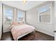 Cozy bedroom featuring hardwood floors, neutral walls and a bright window with white curtains at 4458 Dunblane Ave, Sugar Hill, GA 30518