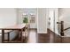 Dining room featuring dark hardwood floors, ample natural light, and seating at 4458 Dunblane Ave, Sugar Hill, GA 30518