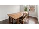 Dining room with hardwood floors, a dining table, and a large window at 4458 Dunblane Ave, Sugar Hill, GA 30518