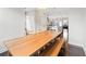 Dining room with hardwood floors, large dining table, and an open layout into other areas at 4458 Dunblane Ave, Sugar Hill, GA 30518