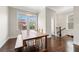 Dining room featuring dark hardwood floors, ample natural light, and an inviting atmosphere at 4458 Dunblane Ave, Sugar Hill, GA 30518
