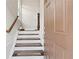 Inviting entryway with hardwood stairs and a view into the home's interior at 4458 Dunblane Ave, Sugar Hill, GA 30518