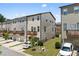View of townhomes with private decks, garages, and well-maintained lawns at 4458 Dunblane Ave, Sugar Hill, GA 30518