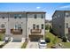 Aerial view of townhome with private decks, garages, and well-maintained lawns at 4458 Dunblane Ave, Sugar Hill, GA 30518