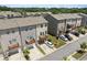 View of townhouse exteriors with driveways and front balconies on a sunny day at 4458 Dunblane Ave, Sugar Hill, GA 30518
