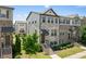 Well-maintained townhome with brick and stone facade, covered porch, and tidy landscaping at 4458 Dunblane Ave, Sugar Hill, GA 30518