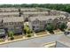 Street-level view of townhouse exteriors featuring brick and siding facades at 4458 Dunblane Ave, Sugar Hill, GA 30518