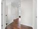 Second floor hallway featuring hardwood floors, neutral paint, and view of bedroom through doorway at 4458 Dunblane Ave, Sugar Hill, GA 30518