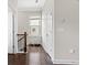Upstairs hallway with hardwood floors, neutral paint, and natural light from the window at 4458 Dunblane Ave, Sugar Hill, GA 30518