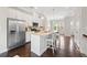 Bright kitchen with stainless steel appliances, granite countertops, and an island with seating at 4458 Dunblane Ave, Sugar Hill, GA 30518