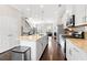 Bright kitchen with stainless steel appliances, granite countertops, and dark wood flooring at 4458 Dunblane Ave, Sugar Hill, GA 30518