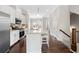 Bright kitchen with stainless steel appliances, granite countertops, and an island with seating at 4458 Dunblane Ave, Sugar Hill, GA 30518