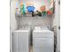 Functional laundry room featuring a washer, dryer, and storage shelf at 4458 Dunblane Ave, Sugar Hill, GA 30518