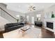 Spacious living room with a fireplace, large windows, comfortable seating, and bright natural light at 4458 Dunblane Ave, Sugar Hill, GA 30518