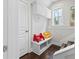 Mudroom with built-in storage, coat hooks, and a view of the stairway at 4458 Dunblane Ave, Sugar Hill, GA 30518