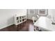 Office area with two large windows, hardwood flooring, white desk and chairs, and white storage shelves at 4458 Dunblane Ave, Sugar Hill, GA 30518