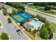 Overhead view of pool and tennis court with parking, trees and roadways nearby at 4458 Dunblane Ave, Sugar Hill, GA 30518