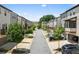 Street view of townhouses with garages, landscaping, and tree-lined street at 4458 Dunblane Ave, Sugar Hill, GA 30518