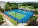 Aerial view of a well-maintained, modern tennis court with lighting for evening play at 4458 Dunblane Ave, Sugar Hill, GA 30518