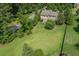 Aerial view of a home on a large lot featuring a well-manicured lawn and a backyard patio space at 4547 Meadow Green Nw Ln, Acworth, GA 30101