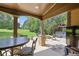 A beautiful covered back porch with a fireplace, dining table, and a view of the backyard at 4547 Meadow Green Nw Ln, Acworth, GA 30101