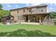 Expansive backyard with a patio, hot tub gazebo, grilling area, and well-maintained lawn at 4547 Meadow Green Nw Ln, Acworth, GA 30101