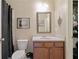 Cozy bathroom features a shower with curtain, framed mirror, vanity with drawers, and toilet at 4547 Meadow Green Nw Ln, Acworth, GA 30101