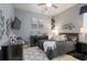 A modern bedroom features a queen bed, a ceiling fan, and minimalist decorations at 4547 Meadow Green Nw Ln, Acworth, GA 30101