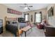 Bedroom with decorative wall art, a ceiling fan, and multiple seating options at 4547 Meadow Green Nw Ln, Acworth, GA 30101