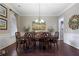 Elegant dining room with dark wood table, seating for eight, and decorative mirrors at 4547 Meadow Green Nw Ln, Acworth, GA 30101