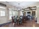 View of open concept dining room that opens to the living room featuring hardwood floors and a glass-top table at 4547 Meadow Green Nw Ln, Acworth, GA 30101