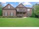 Beautiful brick two-story home featuring well-manicured landscaping and charming shutters at 4547 Meadow Green Nw Ln, Acworth, GA 30101