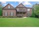 Inviting brick two-story home featuring manicured lawn and symmetrical architectural details at 4547 Meadow Green Nw Ln, Acworth, GA 30101