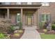 Inviting front porch with decorative columns, stone accents, and manicured landscaping at 4547 Meadow Green Nw Ln, Acworth, GA 30101