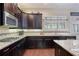 Modern kitchen with granite countertops, stainless steel appliances, and dark cabinets at 4547 Meadow Green Nw Ln, Acworth, GA 30101