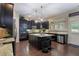 Gourmet kitchen featuring an island with seating, stainless steel appliances, and dark wood cabinets at 4547 Meadow Green Nw Ln, Acworth, GA 30101