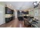 Spacious kitchen with dark cabinetry, stainless steel appliances, and granite countertops at 4547 Meadow Green Nw Ln, Acworth, GA 30101
