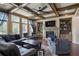 Spacious living room featuring a stone fireplace, built-in shelving, and a coffered ceiling at 4547 Meadow Green Nw Ln, Acworth, GA 30101