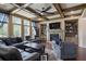 Comfortable living room featuring a stone fireplace, built-in shelving, and a coffered ceiling at 4547 Meadow Green Nw Ln, Acworth, GA 30101