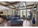 Open living room with coffered ceilings, built-in bookshelves, stone fireplace, and hardwood floors at 4547 Meadow Green Nw Ln, Acworth, GA 30101