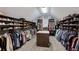 A large walk-in closet featuring custom shelving and rods for organization at 4547 Meadow Green Nw Ln, Acworth, GA 30101