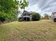 Spacious backyard with mature trees and a screened-in porch, perfect for outdoor living at 237 Shockley Way, Dallas, GA 30157