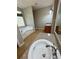 Bright bathroom featuring a soaking tub, granite countertop, and a large window at 237 Shockley Way, Dallas, GA 30157