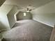 Huge carpeted bonus room offers flexibility and is equipped with a ceiling fan and a window at 237 Shockley Way, Dallas, GA 30157