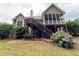 Back exterior with a wooden deck, stairs and a screened-in porch at 237 Shockley Way, Dallas, GA 30157