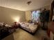 View of bedroom with full size bed, decorative tree, side tables, and curtains at 25 Dogwood Dr Nw, Cartersville, GA 30121