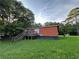 Exterior view of home with green lawn, wooden deck, and mature trees at 25 Dogwood Dr Nw, Cartersville, GA 30121