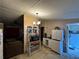 View of the kitchen with chandelier, white cabinets, microwave, and appliances at 25 Dogwood Dr Nw, Cartersville, GA 30121