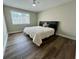 Minimalist bedroom featuring a queen bed, dark wood floors, and natural light at 405 Fairburn Sw Rd # 231, Atlanta, GA 30331