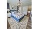 Cozy bedroom featuring a stylish rug, eye-catching light fixture, and comfortable blue bed frame at 405 Fairburn Sw Rd # 231, Atlanta, GA 30331